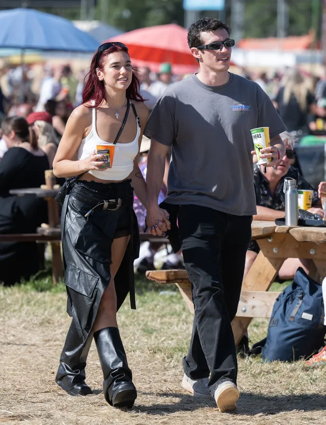 Dua Lipa holding hands with Callum Turner at the Glastonbury festival