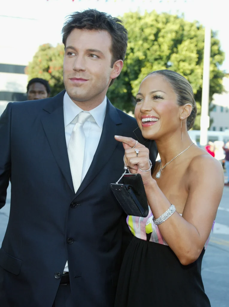 Jennifer Lopez flaunts her engagement ring from Ben Affleck during the premiere of their 2002 film Gigli