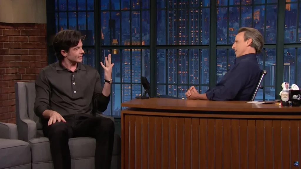 John Mulaney shows off his wedding band to host Seth Meyers