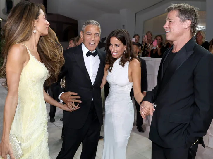 Amal Clooney, George Clooney, Ines De Ramon, and Brad Pitt sharing laughs on the red carpet