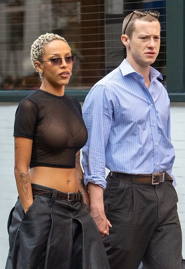 Doja Cat and Joseph Quinn hold hands while taking a stroll in London