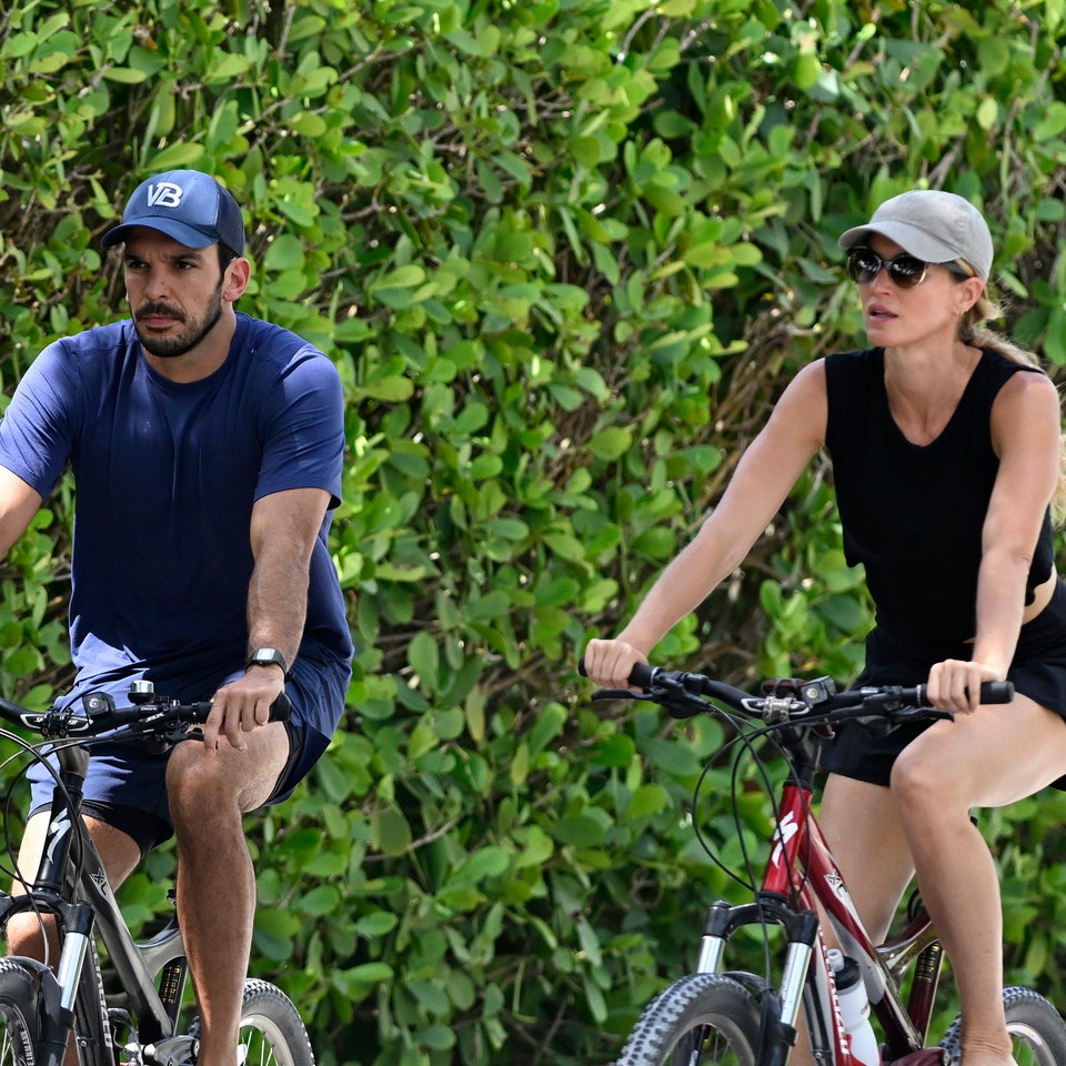 Gisele Bündchen and Joaquim Valente riding a bicycle together