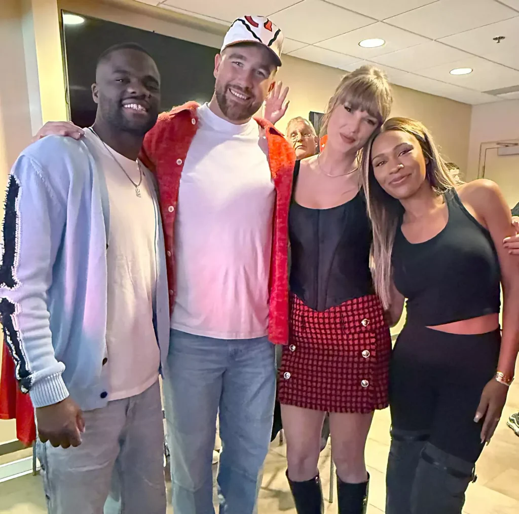 Frances Tiafoe, Travis Kelce, Taylor Swift, and Ayan Broomfield pose for a photo together