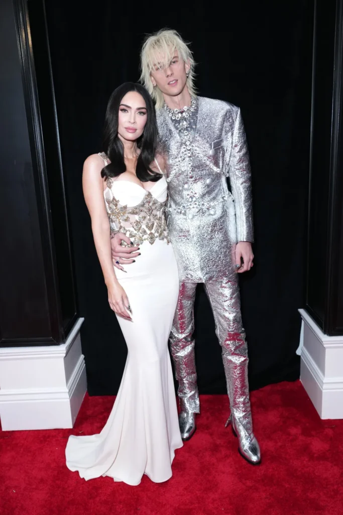 Machine Gun Kelly and Megan Fox posing on the red carpet of an event