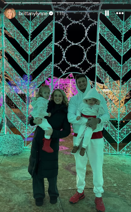 Patrick and Brittany Mahomes with their daughter and son at a Christmas themed skating rink