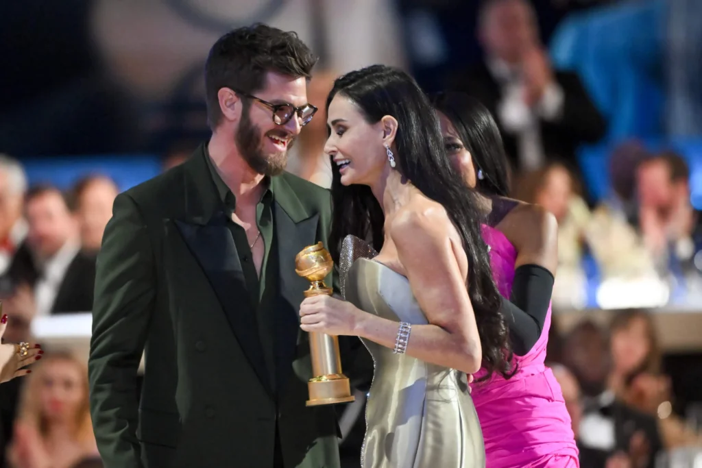 Andrew Garfield presenting Demi Moore with her award at the 2025 Golden Globes